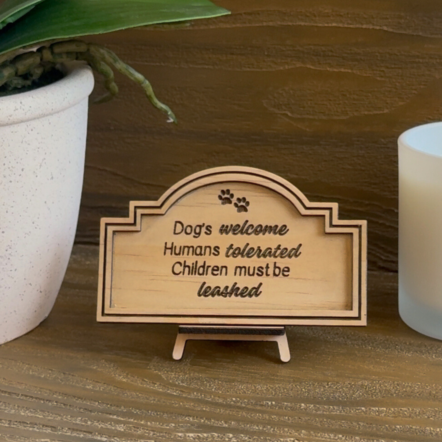 Cute Miniature Pine Plywood sign with easel stand featuring a laser engraved quote "Dog's Welcome, Humans Tolerated, Children must be leashed" Approx 6cm High and 10cm Wide. 